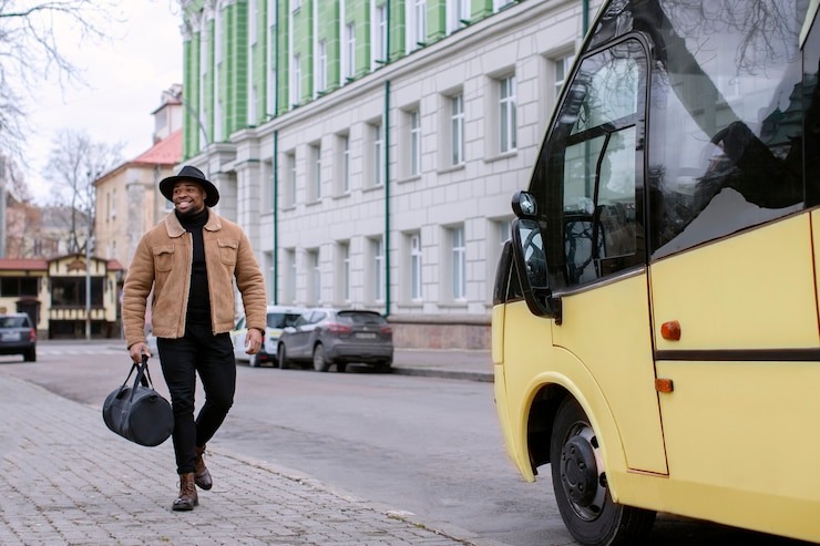 A man walking towards his hired minibus