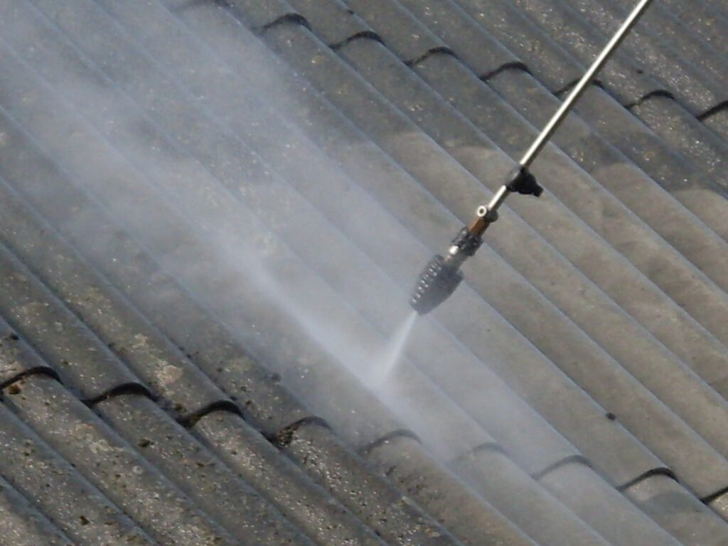 Professionals carrying out pressure wash roof cleaning in Auckland